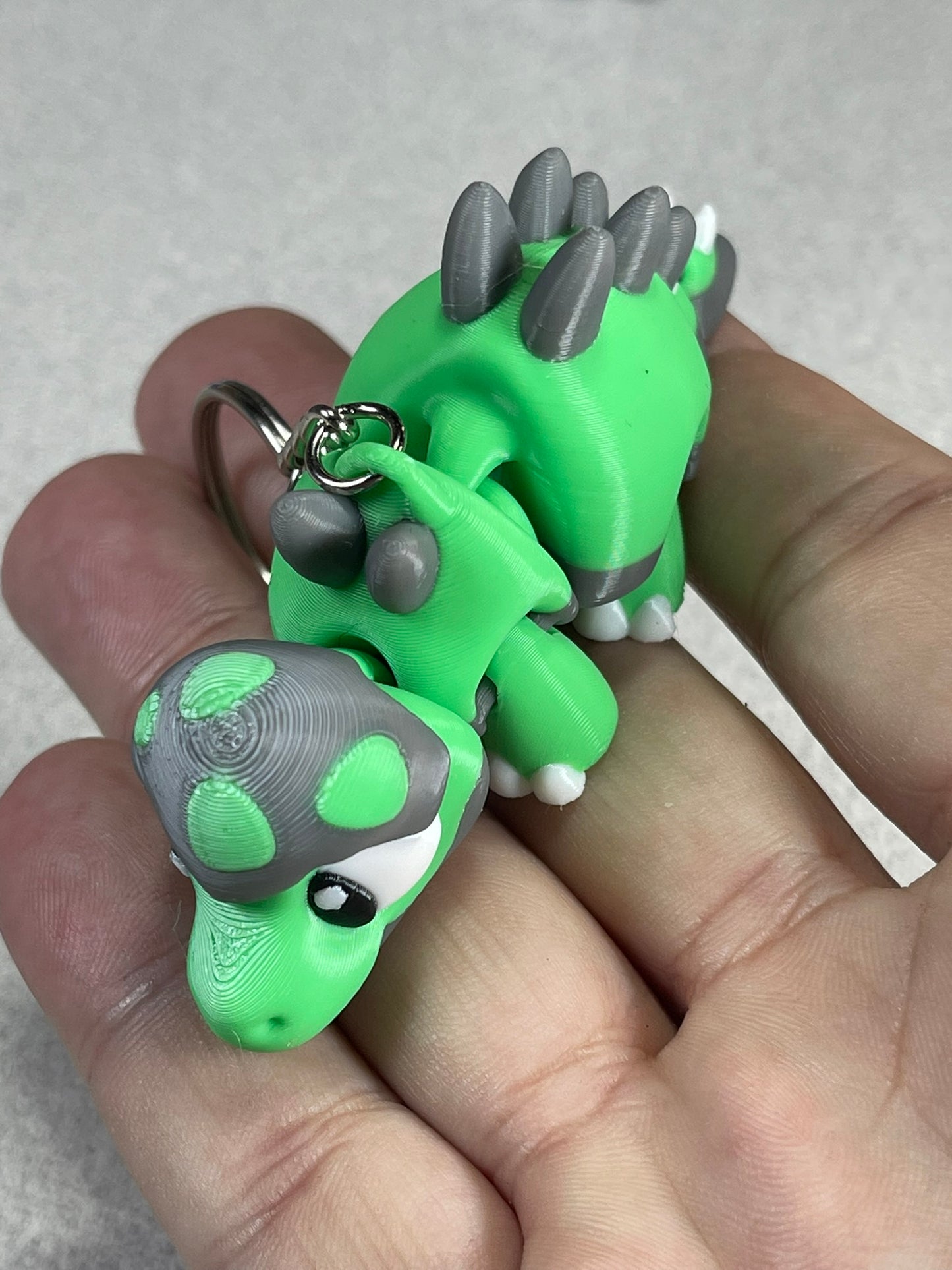 Tiny Green Stegosaurus Snuggle Keychain