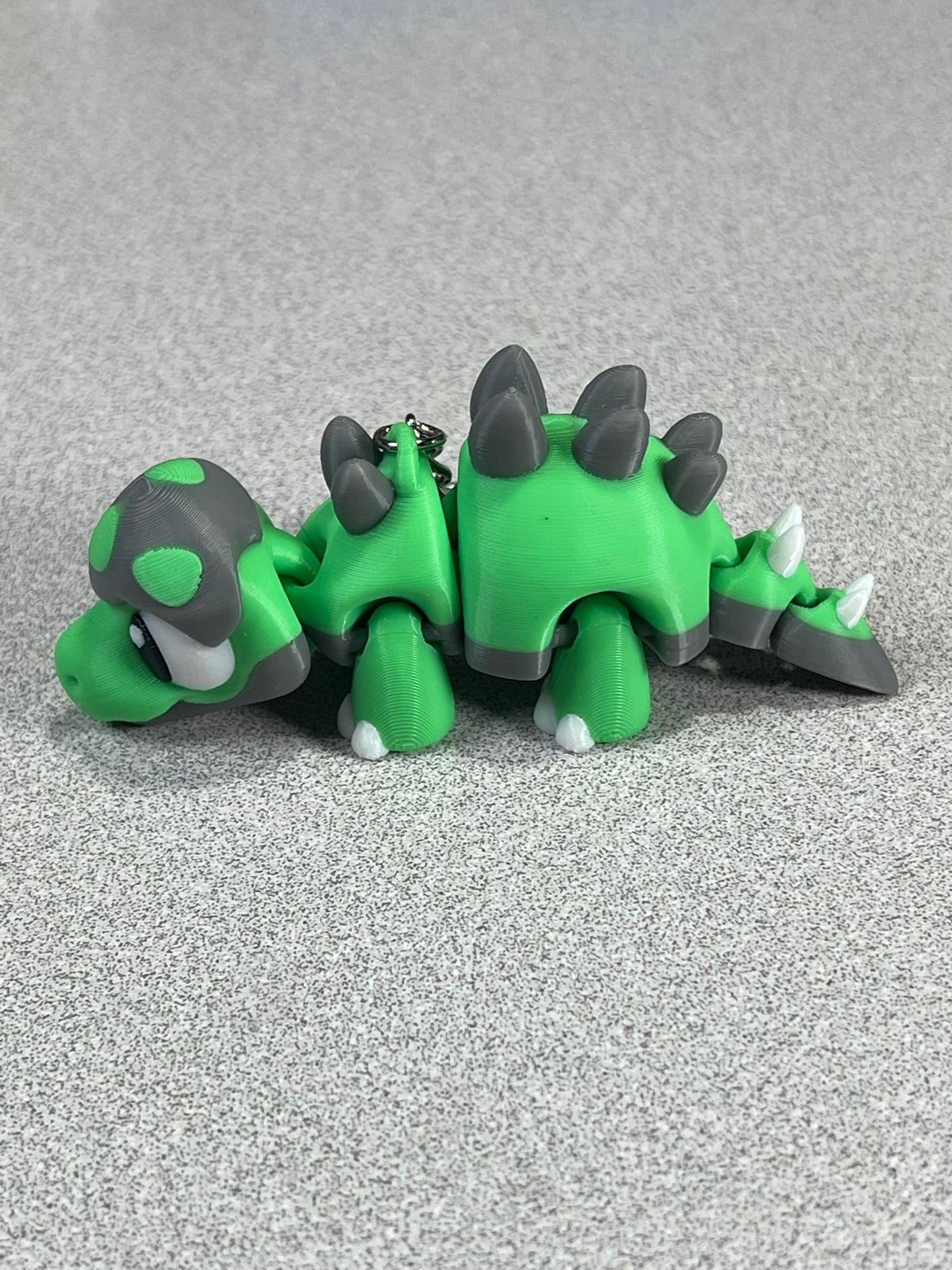 Tiny Green Stegosaurus Snuggle Keychain