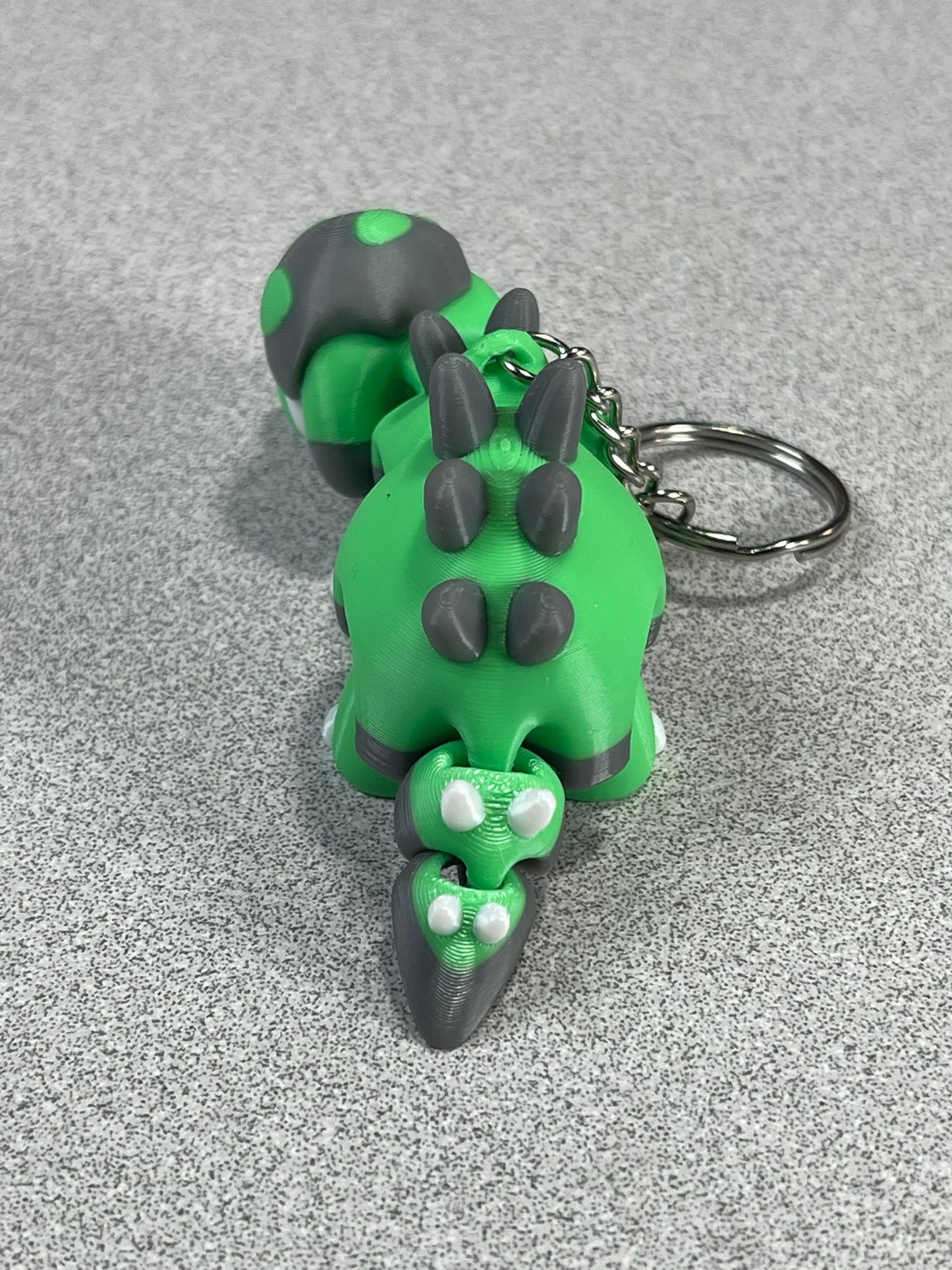 Tiny Green Stegosaurus Snuggle Keychain