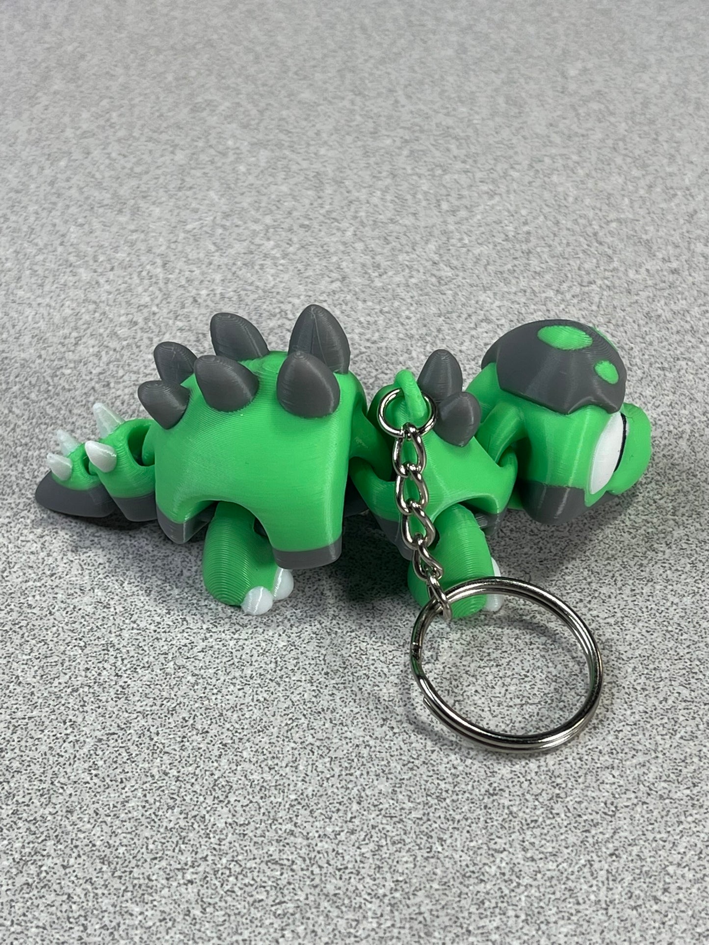 Tiny Green Stegosaurus Snuggle Keychain