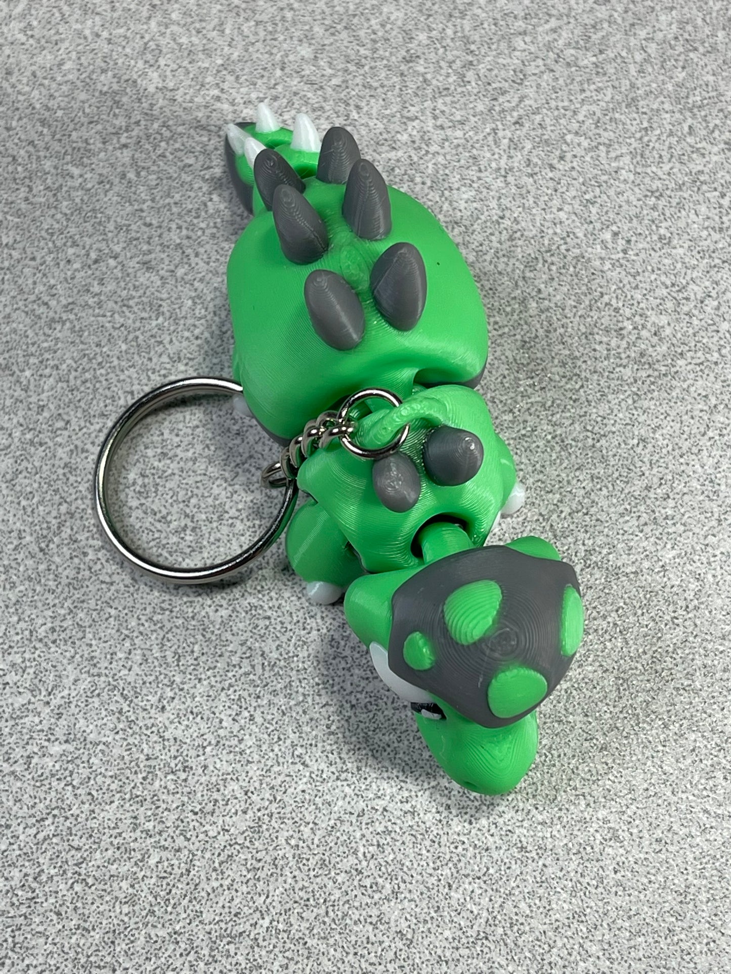 Tiny Green Stegosaurus Snuggle Keychain