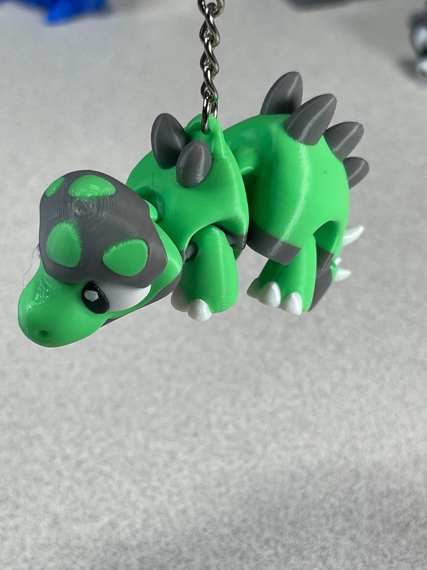 Tiny Green Stegosaurus Snuggle Keychain